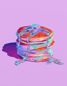 a stack of pancakes sitting on top of a purple table next to a pink wall