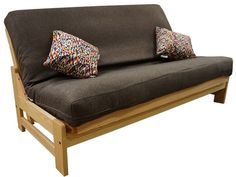 a futon couch with two pillows on it's back and one arm folded down