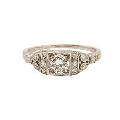 A dazzling white G colored, VS1 European cut diamond of approximately. 40 carats shines forth from this finely detailed Edwardian era platinum engagement ring. The center diamond is highlighted on either side by a row of three prong set sparkling round diamonds terminating in graceful shoulders which each highlight two round diamonds. The total carat weight of the mounting is approximately .45 carats. Current ring size 6.5 and may be resized. PERIOD - Edwardian STONE - Diamond STONE QUALITY - G Timeless Classic Cut Diamond Ring With Single Cut Diamonds, Timeless Silver Diamond Ring With Single Cut Diamonds, Timeless Diamond Ring With Single Cut Diamonds, Timeless Diamond Ring With Single Cut, Timeless Platinum Diamond Ring In Diamond White, Diamond White Classic Cut Diamond Ring For Wedding, Timeless Diamond White Single Cut Diamond Ring, Timeless Single Cut Diamond Ring, Formal Diamond White Platinum Diamond Ring