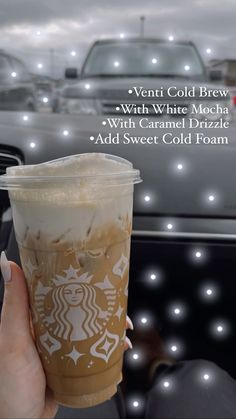 a person holding up a starbucks drink in front of a car with the words, venti cold brew with white mocha and caramel latte add sweet cold foam