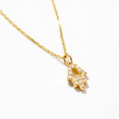 1- D E S C R I P T I O N Unveil your inner strength with our Diamond Hamsa Hand Necklace in 14K Solid Gold. An exquisite symbol of protection, this Evil Eye Necklace for women features a Hamsa Hand Pendant, making it an ideal gift for her. Handcrafted with love, this piece adds a touch of elegance to any outfit, promoting positive energy and warding off negativity. 2- P R O D U C T ∙  F E A T U R E S * Gold material: 14k solid gold * Gold color options: Yellow gold, Rose gold, White gold * Stone: Diamond Diamond Carat: 0.07 ct. Diamond Clarity: VS2 Diamond Color: F-G Diamond Cut: Excellent Diamond Setting: Pave setting * Choice of chain length: 14", 16", 18", 20" * Dimensions: Pendant Height: 7 mm / 0.27 in Pendant Width: 5 mm / 0.19 in 3- D E L I V E R Y ∙ D E T A I L S We understand that Gift Yellow Gold Diamond Necklace Si Clarity, Yellow Gold Diamond Necklace With Si Clarity As Gift, Yellow Gold Si Clarity Diamond Necklace Gift, Symbolic 14k Gold Jewelry With Adjustable Chain, 14k Gold Symbolic Jewelry With Adjustable Chain, Symbolic White Gold Tarnish-resistant Necklace, Symbolic Sterling Silver Necklace With Delicate Chain, Women Protection, Hamsa Hand Necklace