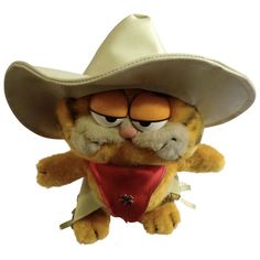 a stuffed animal wearing a cowboy hat and bandanna with eyes wide open in the shape of a cat