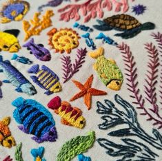 an embroidery project with colorful fish and plants