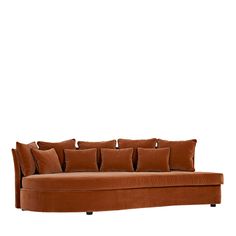 a brown couch with lots of pillows on the top and bottom, in front of a white background