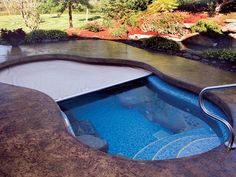 an outdoor hot tub in the middle of a garden