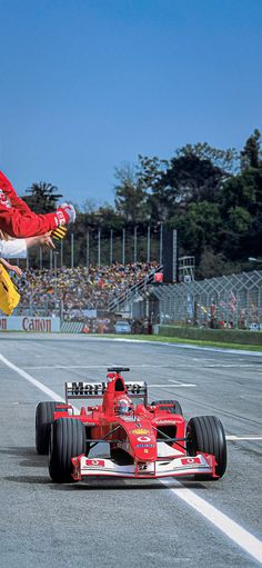 a person jumping over a race car in the air