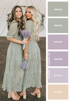 two women standing next to each other holding flowers