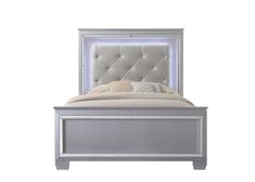 a white bed with an upholstered headboard and foot board