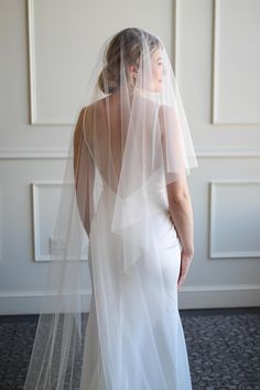 a woman in a wedding dress wearing a veil