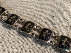 Vintage Siam sterling silver panel bracelet.  13 Niello surfaced panels each etched with Suvannamaccha, a mermaid princess.  Excellent condition.  Bracelet is 7" long x 3/8" wide. Engraved Sterling Silver Bracelet Collectible, Mermaid Princess, Naples Fl, Bracelet Vintage, A Mermaid, Chain Link Bracelet, Naples, Link Bracelets, Chain Link