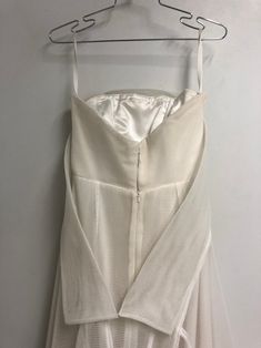 a white dress hanging on a hanger