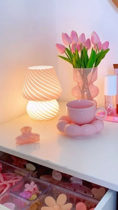 a white table topped with lots of pink items