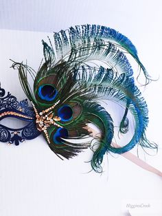 Stunning masquerade mask, peacock feather Masquerade Masks, Gold Navy theme Jewels & Feathers This filigree laser cut mask painted in Black or Navy Blue and embellished with Rhinestones and adorned with Peacock feathers. Ribbons attached can be black or gold, pls leave a check out note if you have a preference. If you pick the custom stone option, leave a note during check out with the colors you would like and a contact number to send pics for approval. Thank you for supporting small busine Peacock Mask, Elegant Face Mask, Peacock Costume, Opera Mask, Mask Images, Metal Mask, Mask Painting, Masquerade Masks, Prom Dance