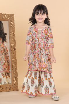 Combine tradition and fashion in this beautiful kurta set from Adiva - perfect for your little girl's next big event. Paired with flats and bangles. This ethnic suit consists of a block printed fit and flared Anarkali Kurti and a pair of sharara. The soft cotton fabric makes the dress most comfortable and stylish, sharara set has a flared bottom hem. Anarkali Dress Matching Set For Diwali, Festive Anarkali Dress With Matching Set, Diwali Anarkali Dress With Matching Set, Festive Multicolor Matching Set Dresses, Festive Cotton Dress Matching Set, Festive Matching Set Dress For Diwali, Traditional Multicolor Dresses With Matching Set, Festive Cotton Dress With Matching Set, Festive Diwali Matching Set Dress