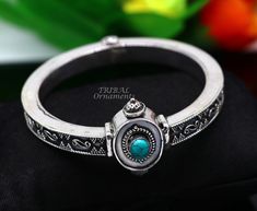 Handcrafted 925 sterling silver fabulous turquoise bangle bracelet kada. fabulous attractive design work silver jewelry with amazing locking system, excellent wedding or party jewelry/gifting jewelry from India. Metal-925 sterling silver. Type-Bangle/bracelet/kada. Width of bangle-0.8 centimeter. Size-2-6 or 2.375 inches or 6.0 cm inner diameter(2-6/2-7 comfort with both sizes) Weight-53.960 grams approx. for single bangle. Stamped-925. stone part width-3.2 centimeters. Finish-Oxidized. Stone-Tu Silver Openable Bracelets As A Gift, Silver Openable Bracelets For Gift, Silver Openable Bracelet For Gift, Silver Openable Bangle Jewelry, Openable Silver Bangle Jewelry, Openable Bracelet Jewelry Gift, Silver Gemstone Bracelets For Festivals, Single Bangle, Turquoise Bangle