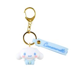 a keychain with a small white sheep on it's side and a name tag attached to it