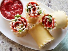 three appetizers on a white plate with sauce