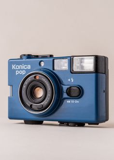 a blue camera sitting on top of a white table