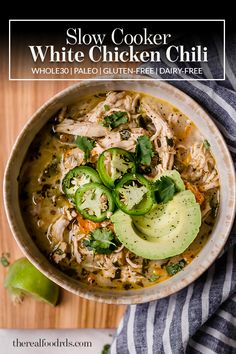 slow cooker white chicken chili in a bowl with avocado and cilantro