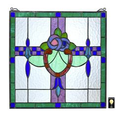 a stained glass window with blue, green and purple designs on the bottom half of it