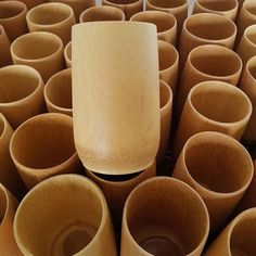 many brown cups are stacked up together