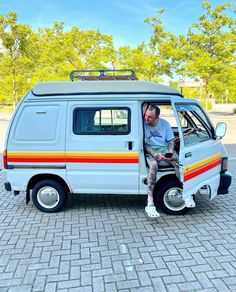 a man sitting in the driver's seat of a van