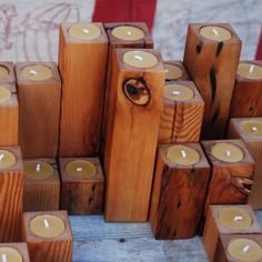 several wooden blocks with lit candles in them sitting on top of a table next to an american flag