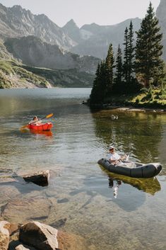 two people are in a canoe on the water