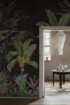 an open door leading to a dining room with a wallpapered mural behind it