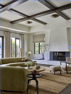 a living room filled with furniture and a fire place in the middle of a room