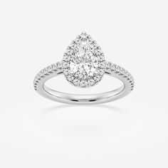 a pear shaped diamond engagement ring on a white background