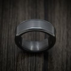 This Black Zirconium ring features:- A Polish Finish- A Beveled Design- 8mm Width- A 5mm Centered Elysium Black Diamond Inlay with a Polish Finish - Please note: This ring is around 3.5mm thick Wedding Titanium Rings With Polished Finish, Titanium Wedding Rings With Polished Finish, Classic Titanium Jewelry For Wedding, Classic Titanium Wedding Jewelry, White Gold Titanium Promise Ring, Round Tungsten Carbide Promise Ring Jewelry, Tungsten Carbide Promise Ring, Formal Titanium Ring Jewelry, Elegant Tungsten Carbide Anniversary Rings