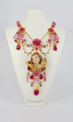 Absolutely Frivolous Pink Cherub Art Nouveau Hand Painted & Gilded Necklace, 24ct Gold Plated with Vintage Czech Drops, Lampwork, Vintage Swarovski Beads, Claw Set Rhinestones and extender chain. We're winging it, that's what Angels do!  Let your soul sparkle and your heart flutter like the wings of an Angel with this truly magical and incredibly unique one of a kind necklace. Cherub Necklace, Cherub Art, Lampwork Bead Necklace, Unique Ornaments, Resin Jewelry Diy, Sweet Jewelry, Angel Jewelry, Necklace Art, Heart Flutter