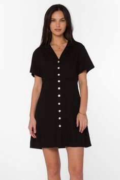 A must-have for any fashion-forward woman, the Sirina Dress is a versatile addition to your wardrobe. This button-up dress features a v-neck, short sleeves, and a lapel collar, elevating the classic design. Look stylish in this timeless piece. Material: 100% Linen Machine wash cold or hand-wash Color: Black Model is 5'9" and wearing a size XS Imported Chic V-neck Single Breasted Mini Dress, V-neck Shirt Dress With Placket For Daywear, Classic V-neck Summer Dress, Classic V-neck Mini Dress For Semi-formal Occasions, Classic V-neck Midi Dress With Buttons, Classic V-neck Shirt Dress For Work, Classic V-neck Shirt Dress With Button Closure, Casual V-neck Shirt Dress With Placket, Fitted V-neck Dress With Short Sleeves For Day Out