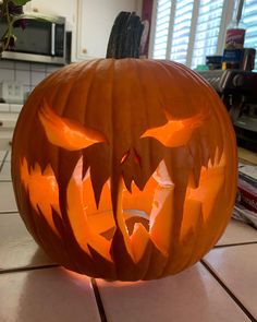 a carved pumpkin sitting on top of a kitchen counter