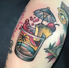 a close up of a person's arm with tattoos on it and an umbrella