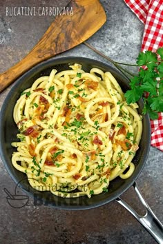 pasta with bacon and parsley in a skillet