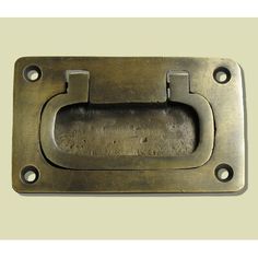 an old metal door handle with holes in the middle on a beige background, showing that there is no image here to provide a caption