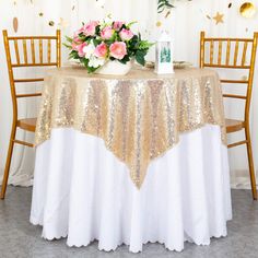 the table is decorated with gold sequins and pink flowers