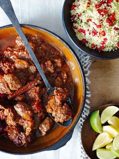 two bowls filled with meat and vegetables next to rice