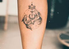 a woman's leg with a tattoo on it and an ornamental design in the middle