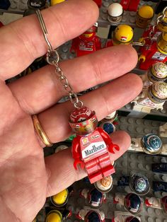 a hand holding a lego minifigure keychain