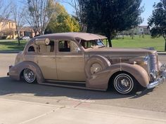 an antique car is parked on the side of the road