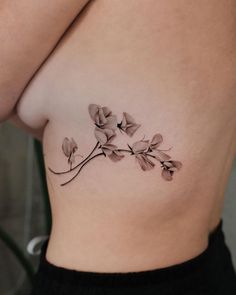 a close up of a woman's stomach with flowers on it