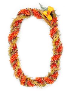 an orange and yellow wreath made out of pine cones