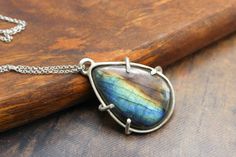 Stunning, one of a kind Rainbow Labradorite pendant Necklace. Perfect for Gifting. Perfect for Layering. Perfect for everyday Wear. Comes with a Sterling Silver chain 4-prong handmade design. Khems Designs Where Spirituality meets Style *| LABRADORITE |* Labradorite Crystal is a stone of magic, awakening within you mystical and magical abilities and psychic powers. They embody within them a deeply felt resonance that is very powerful. They can be used to bring amazing changes to your life and th Untreated Teardrop Pendant Necklace As A Gift, Untreated Teardrop Pendant Necklace For Gifts, Untreated Nature-inspired Pendant Jewelry, One Of A Kind Labradorite Necklaces For Gifts, One-of-a-kind Labradorite Round Pendant Jewelry, Labradorite Necklace For Gifts, Untreated Round Pendant Jewelry Gift, Unique Labradorite Teardrop Pendant Jewelry, Untreated Labradorite For Jewelry Making