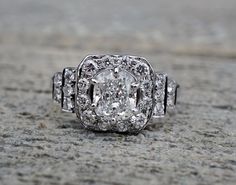 an old - fashioned diamond ring sits on the ground