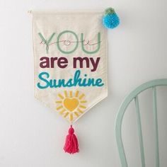 a wall hanging with the words you are my sunshine and a tasseled sun