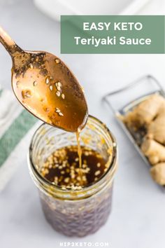 a spoon full of teriya sauce being poured into a jar