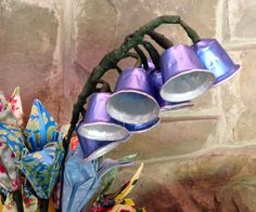 a basket filled with lots of different types of items next to a brick wall and stone wall